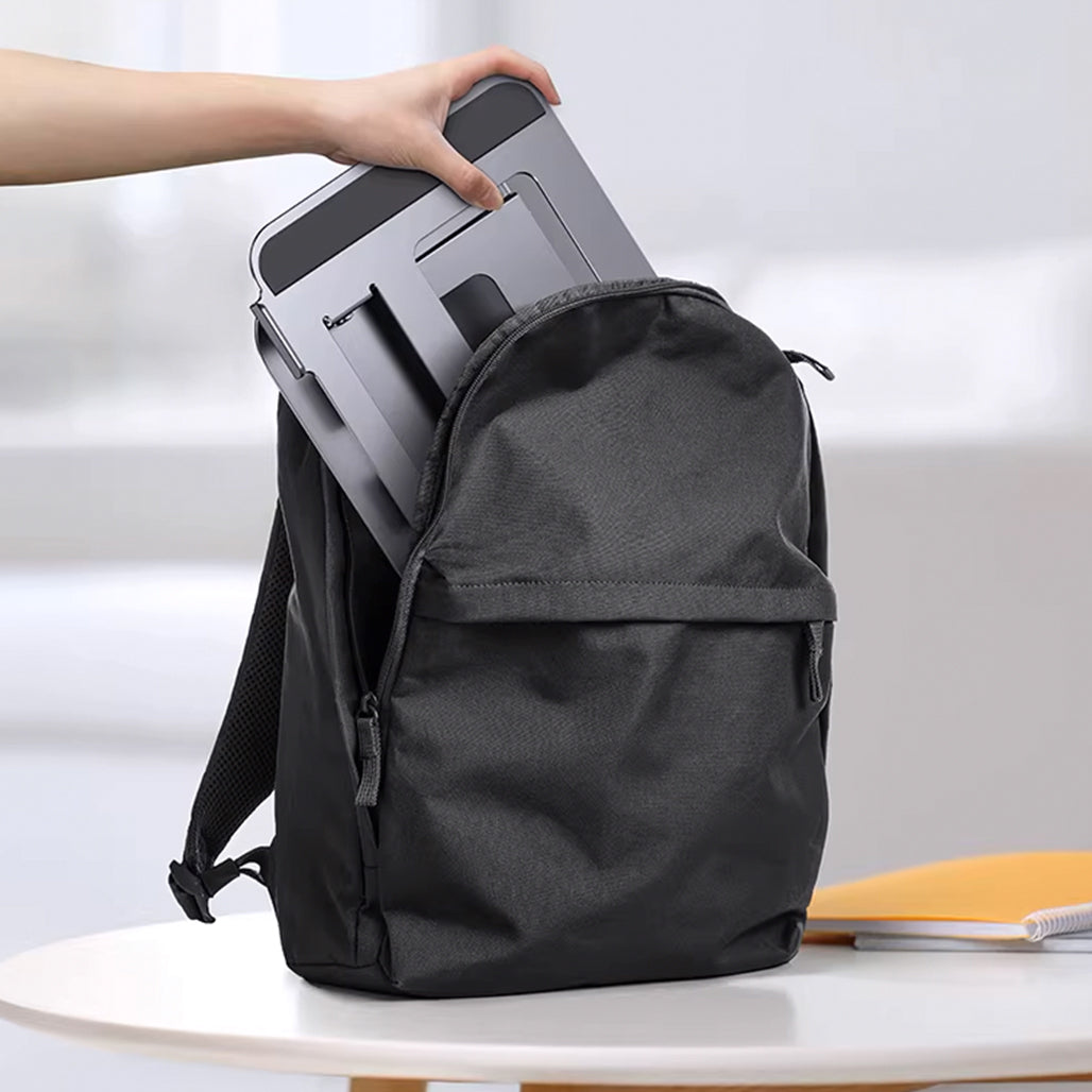 A Photo Of Adjustable Three-Layer Laptop Stand with Folding Storage and Cooling Base – Portable Carbon Steel Vertical Lifting Stand