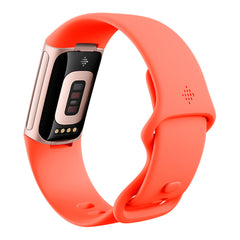 A Photo Of Fitbit Charge 6 - Premium Fitness Tracker - Coral/Champagne Gold Aluminum